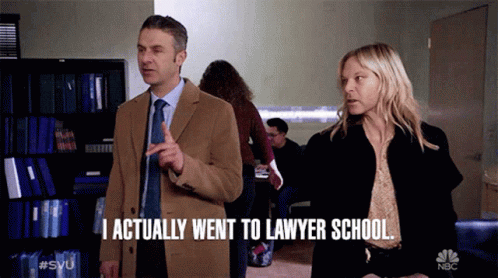 a man and a woman standing next to each other with the man saying i actually went to lawyer school