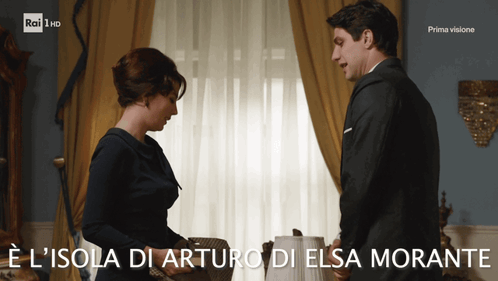 A Man And A Woman Standing Next To Each Other With The Words E L Isola Di Arturo Di Elsa Morante GIF