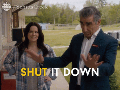 A Man And A Woman Standing Next To Each Other With The Words Shut It Down Written In Yellow GIF