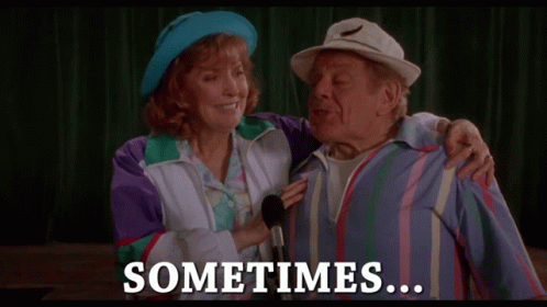 A Man And A Woman Standing Next To Each Other With The Words " Sometimes " On The Bottom GIF