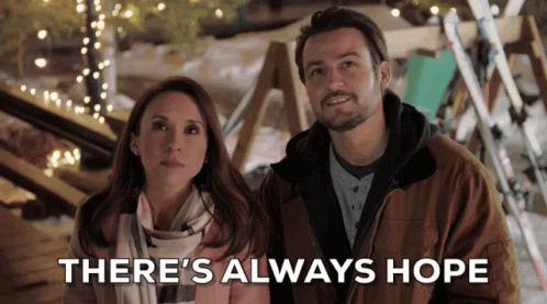 A Man And A Woman Standing Next To Each Other With The Words " There 'S Always Hope " Behind Them GIF