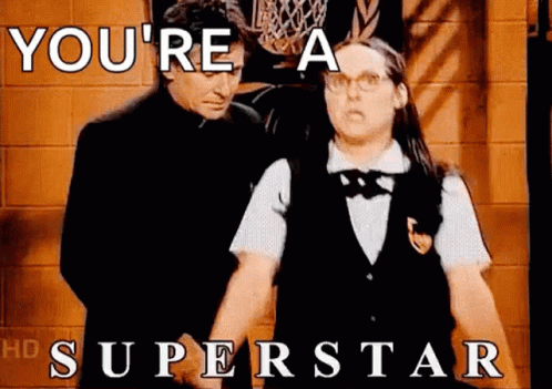 A Man And A Woman Standing Next To Each Other With The Words `` You 'Re A Superstar '' GIF