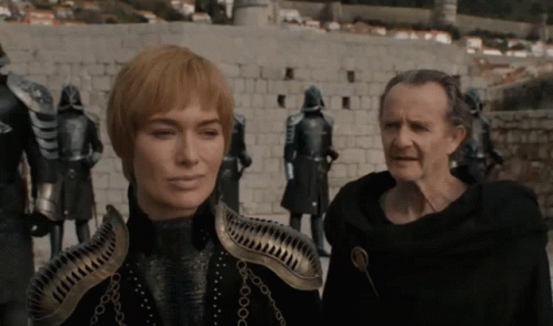 A Man And A Woman Standing Next To Each Other GIF