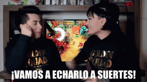 A Man And A Woman Wearing Golden Squad Sweatshirts Are Playing A Video Game GIF
