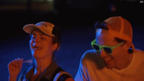 Man And Woman Laughing In Sunglasses And Red Bull Hat GIF