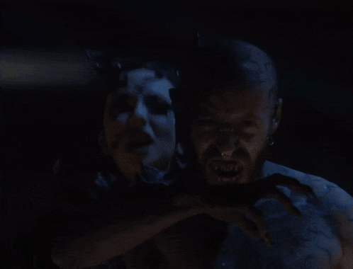 A Man And A Woman With Blue Painted Faces GIF