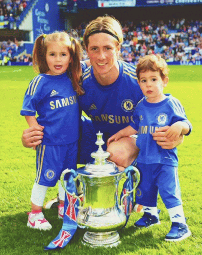 A Man And Two Children Pose For A Picture With A Trophy GIF