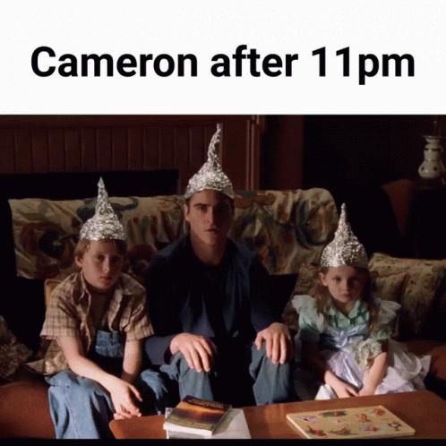 A Man And Two Children Wearing Aluminum Foil Hats Sit On A Couch With The Caption Cameron After 11 Pm GIF