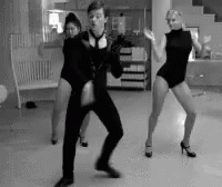 A Man And Two Women Are Dancing Together In A Black And White Photo GIF