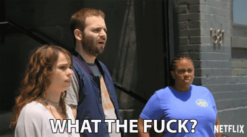 Man And Women Standing In Front Of Brick Building GIF
