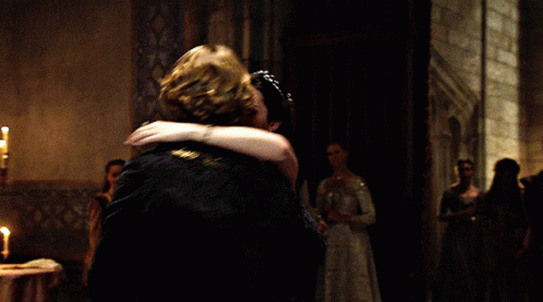 A Man And Woman Are Dancing In A Dark Room GIF