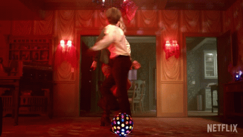 A Man And Woman Are Dancing In A Room With A Netflix Logo On The Bottom GIF