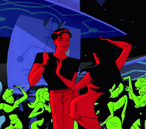 A Man And Woman Are Dancing In Front Of A Crowd Of Green Women GIF
