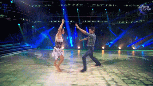 a man and woman are dancing in front of a dancing break sign