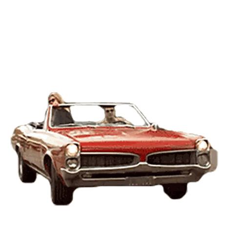 a man and woman are driving a red car