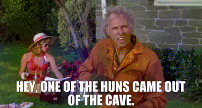 A Man And Woman Are Having A Picnic In The Grass And The Man Is Saying Hey One Of The Huns Came Out Of The Cave GIF
