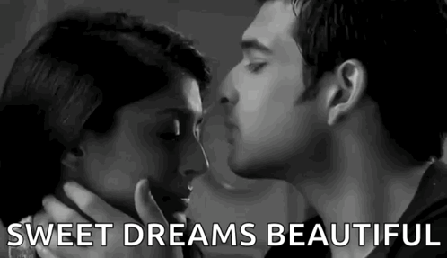 A Man And Woman Are Kissing In A Black And White Photo . GIF