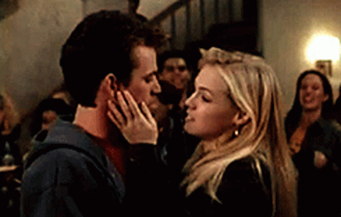 Kissing Couple In Front Of Crowd GIF
