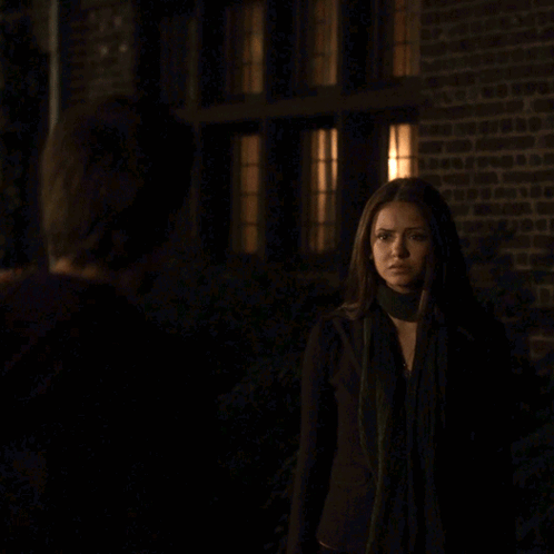 A Man And Woman Are Kissing In The Dark GIF