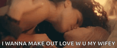 A Man And Woman Are Kissing On A Bed With The Words `` I Wanna Make Out Love W U My Wifey '' GIF