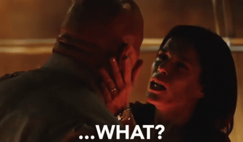 A Man And Woman Are Looking Into Each Other 'S Eyes And The Woman Is Saying " What " GIF