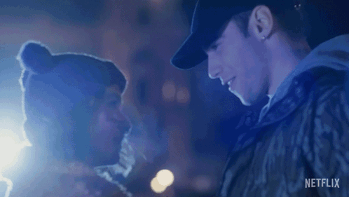 A Man And Woman Are Looking Into Each Other 'S Eyes . GIF