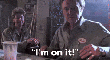 A Man And Woman Are Sitting At A Table And The Man Is Saying I 'M On It GIF