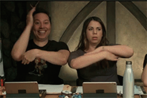 Man And Woman Sitting With Arms Outstretched GIF