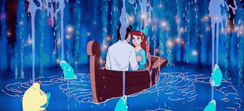 A Man And Woman Are Sitting In A Boat In The Water Surrounded By Sharks . GIF
