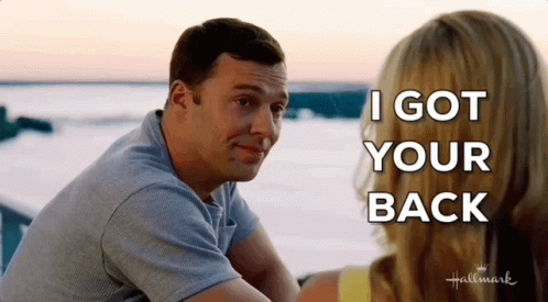 A Man And Woman Are Sitting Next To Each Other And The Man Is Saying I Got Your Back GIF