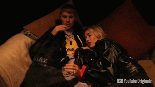 A Man And Woman Are Sitting On A Couch With Youtube Originals In The Corner GIF