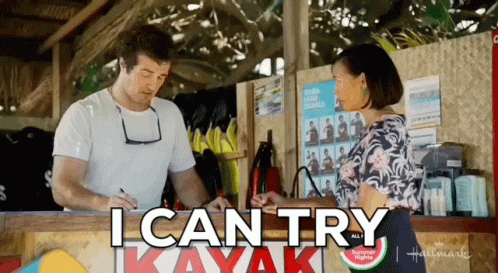 A Man And Woman Are Standing In Front Of A Sign That Says " I Can Try " GIF