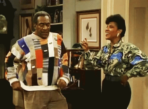 a man and woman are standing next to each other in a living room