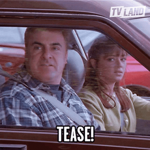 A Man And Woman In A Car With A Tv Land Sticker On The Back Window GIF