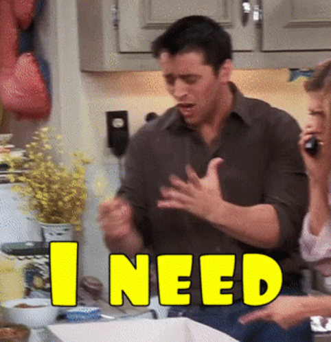 A Man And Woman In A Kitchen With The Word I Need In Yellow GIF