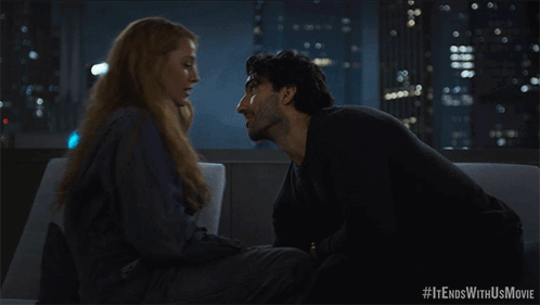 A Man And Woman Kissing On A Couch With #It Ends With Us Movie Written Below Them GIF