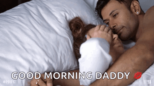 A Man And Woman Laying In Bed With The Words Good Morning Daddy GIF