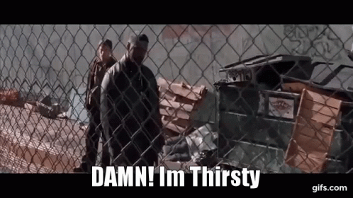 A Man Behind A Chain Link Fence Says " Damn ! Im Thirsty " GIF