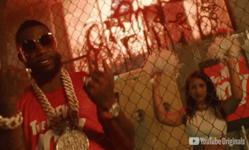A Man Behind A Chain Link Fence With A Youtube Originals Logo GIF