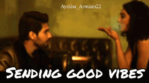 A Man Blowing A Kiss To A Woman With The Words Sending Good Vibes Below Him GIF