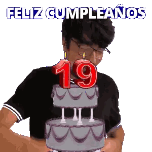 a man blowing out a candle on a birthday cake with the number 19 on it
