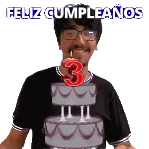 a man blowing out a candle on a cake with the number 3 on it