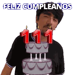 a man blowing out candles on a birthday cake with the words feliz cumpleanos in the background