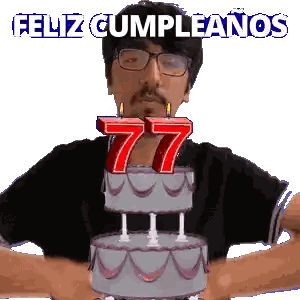 a man blowing out candles on a cake that says 77 on it