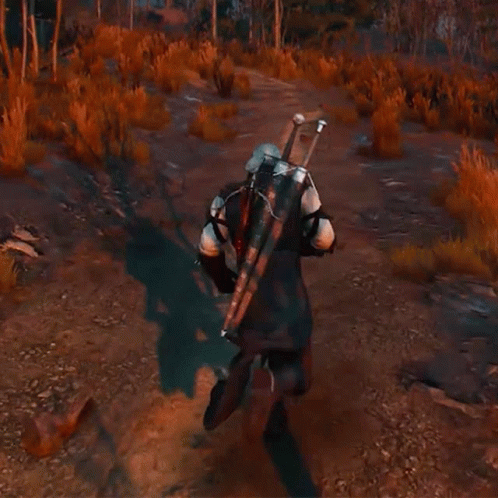 A Man Carrying A Large Sword On His Back Is Walking Down A Dirt Road . GIF