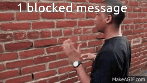 A Man Clapping His Hands In Front Of A Brick Wall With The Words 1 Blocked Message Written Above Him GIF