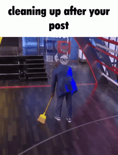 A Man Cleaning Up A Basketball Court With A Tnt Logo In The Background GIF