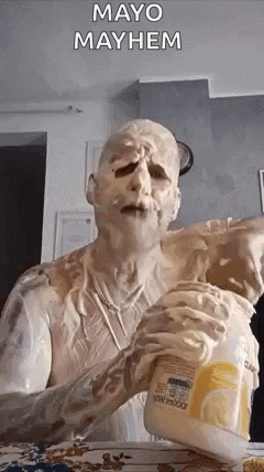 A Man Covered In Mayonnaise Is Holding A Jar Of Mayonnaise . GIF