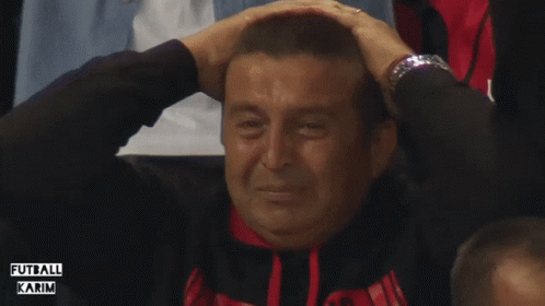 A Man Covering His Ears While Wearing A Watch And A Shirt That Says " Futbol Karim " GIF