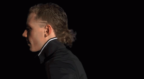 A Man Covering His Face With A Mask With Flames Coming Out Of It GIF